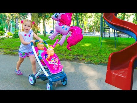 Baby dolls playing with Nastya in the outdoor playground for kids