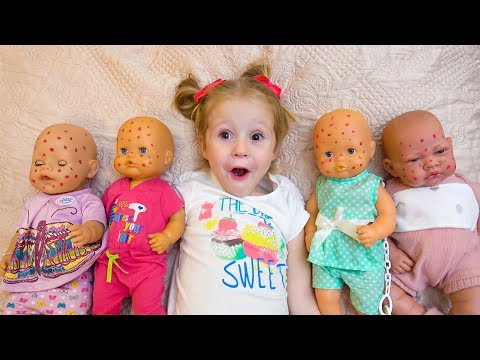 Babies dolls and funny little girl playing together