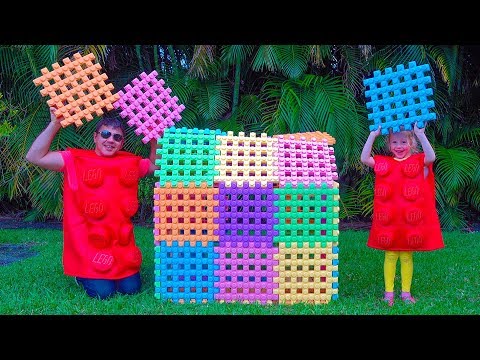 Nastya and papa playing with toy blocks